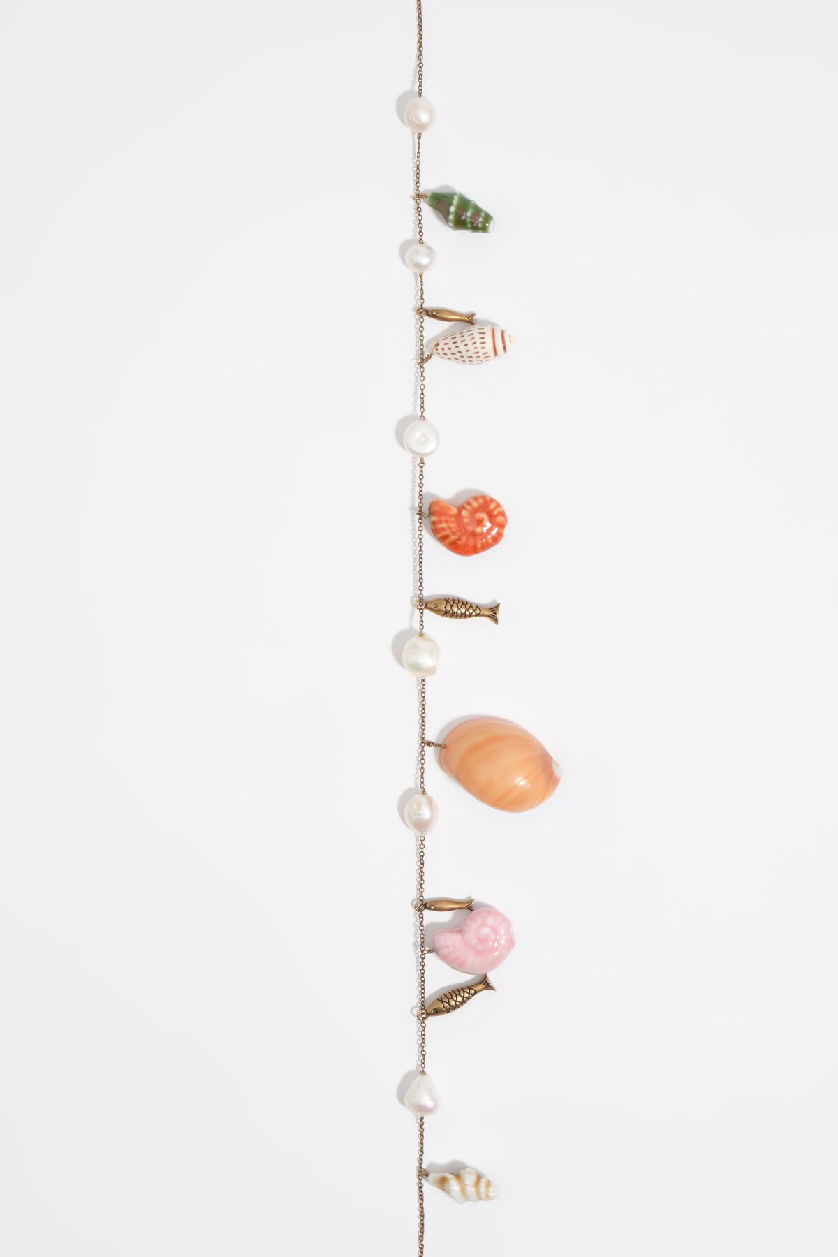 Aged gold necklace with fish and shells