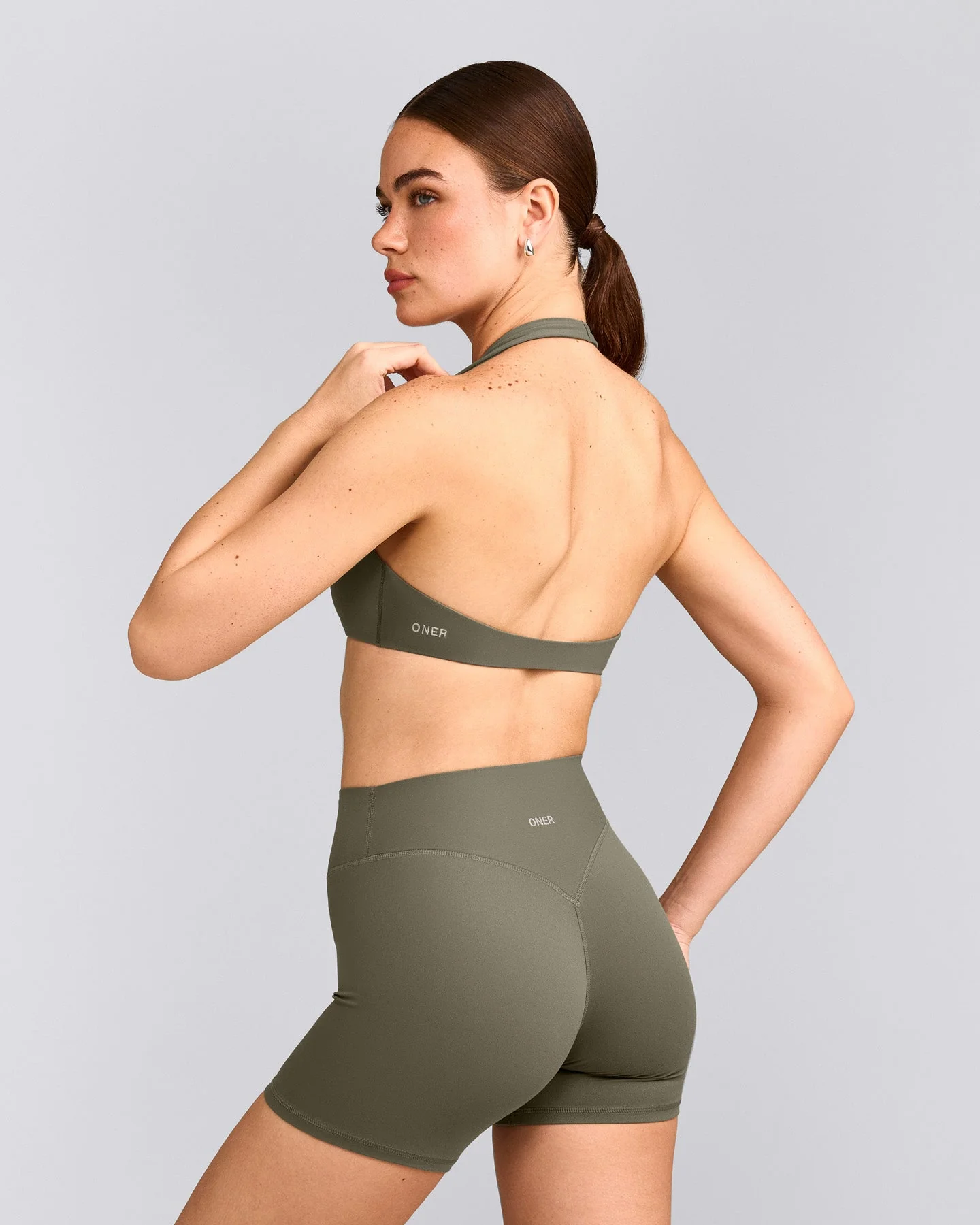 SoftMotion™ Minimal Halter Neck Bralette with Grey Logo | Alpine Green