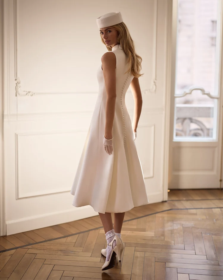 Elegant white midi dress with a high neckline