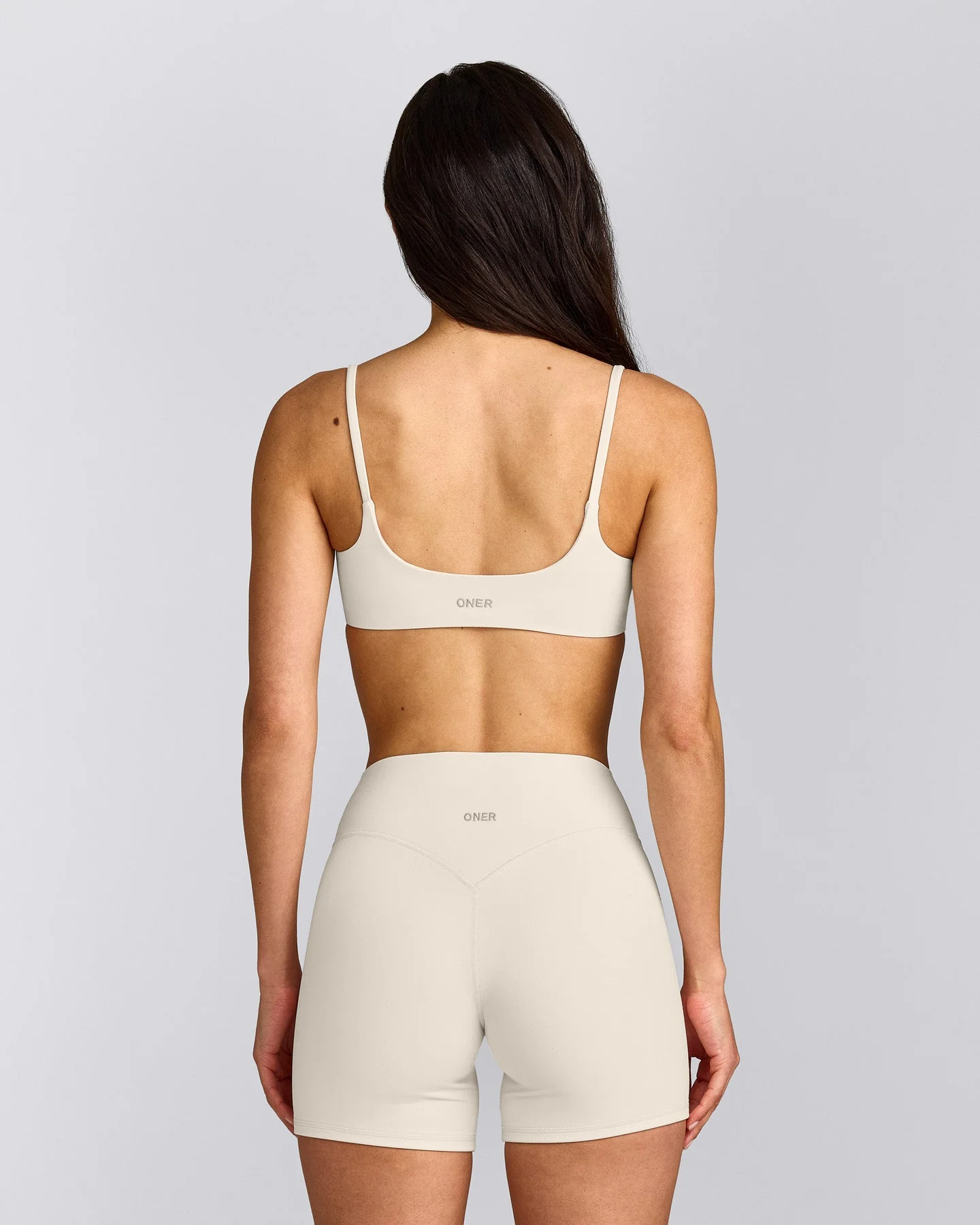 SoftMotion™ Strappy Sports Bra with Grey Logo | Marshmallow White