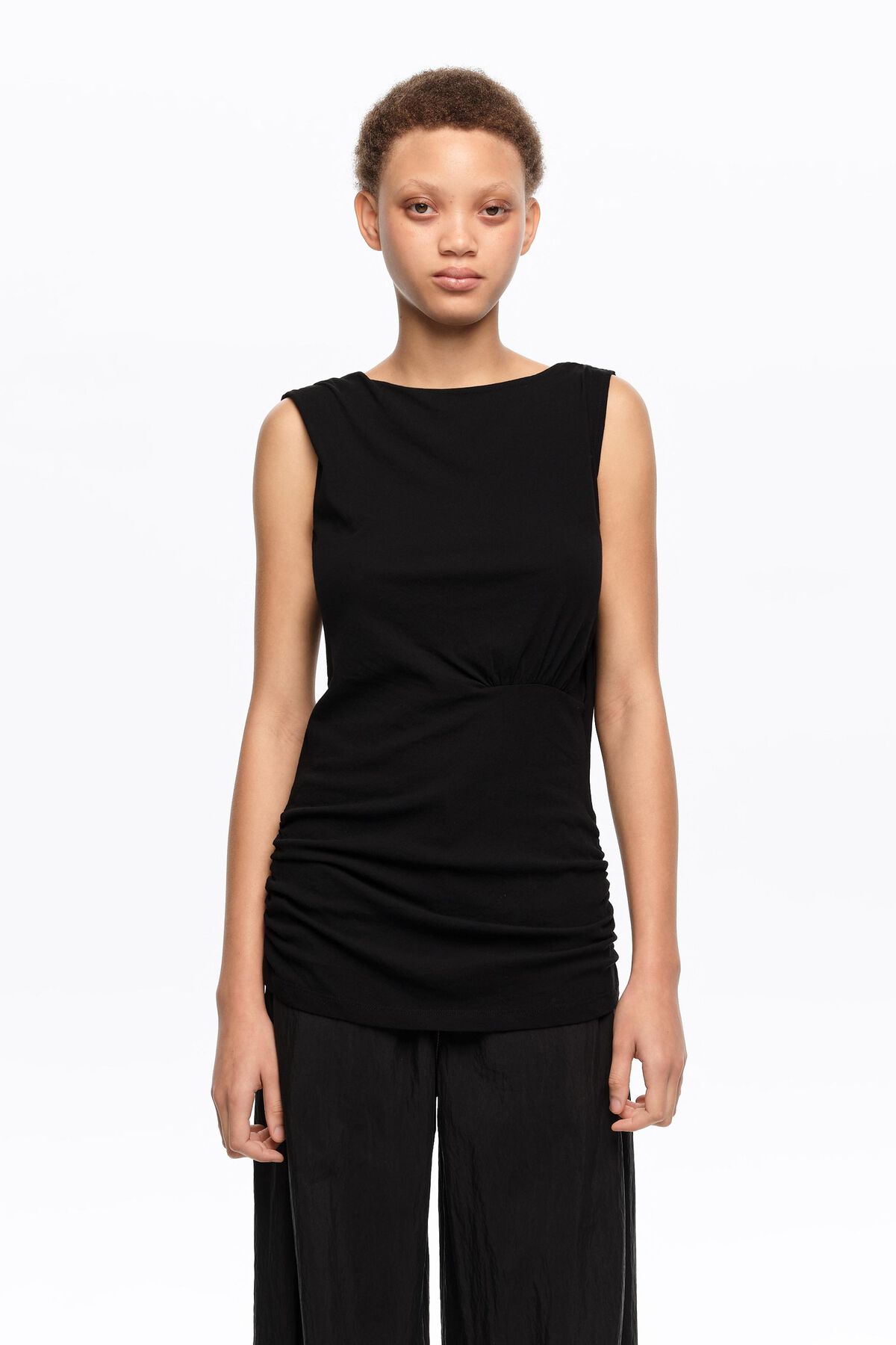 Black fitted elasticated top with dropped back