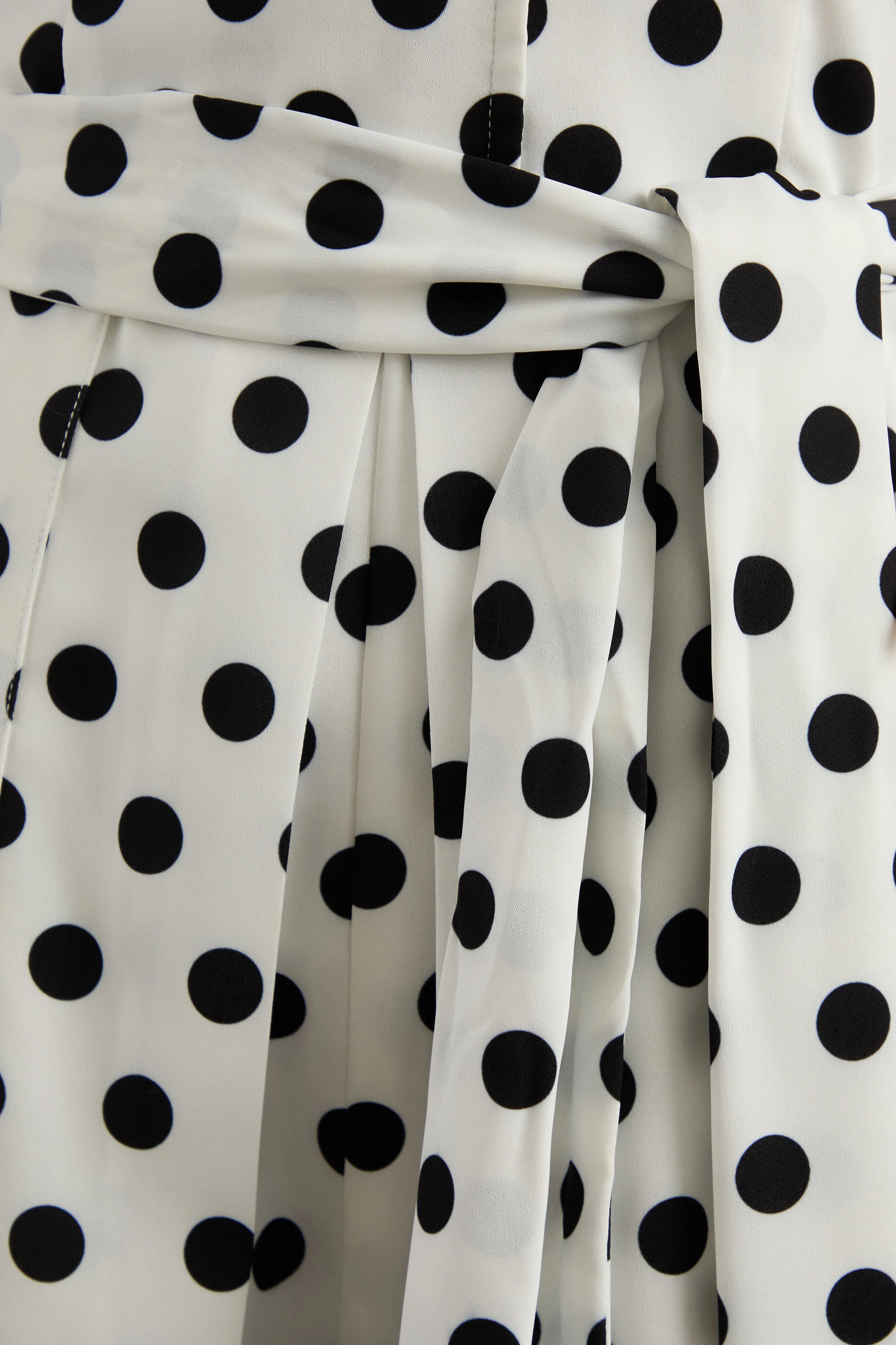 Kerina | White Polka Dot Plunge-Neck Romper With Belt Detail