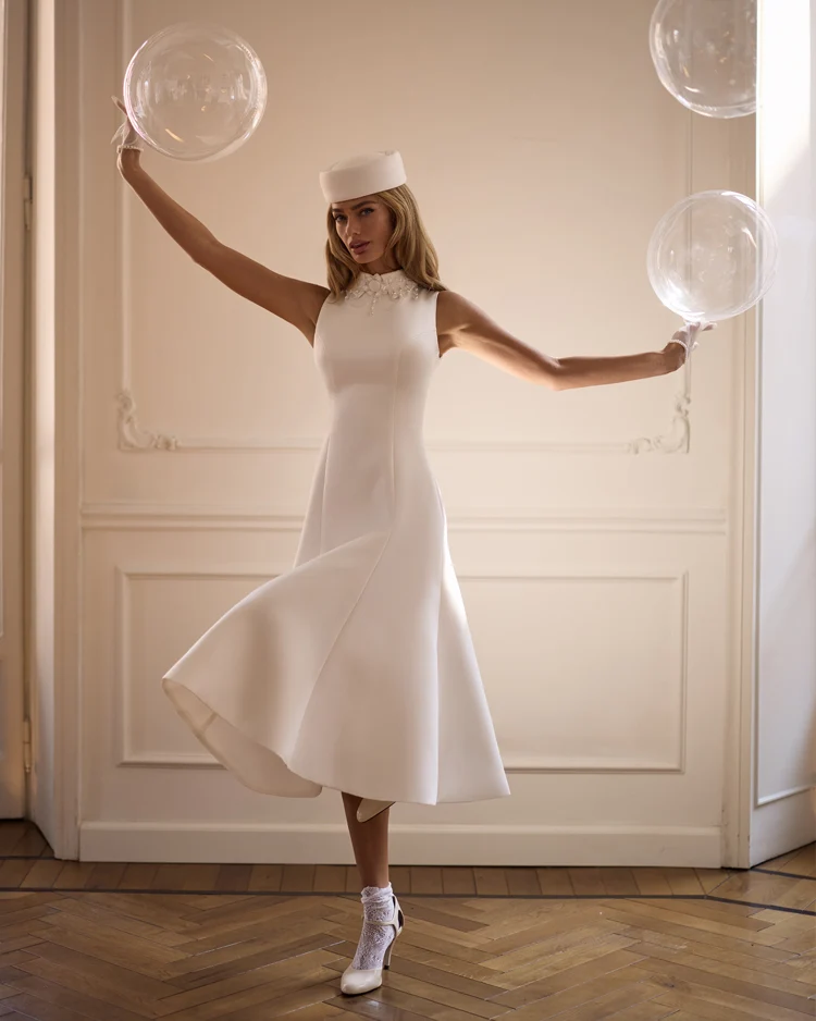 Elegant white midi dress with a high neckline