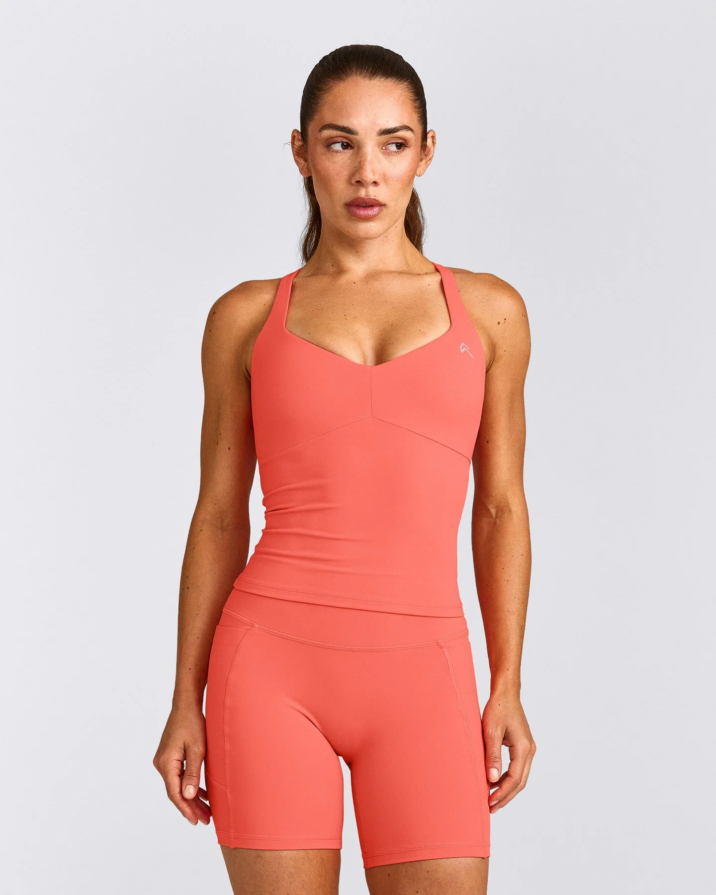 UnifiedMove™ T Back Mid Vest with Built in Bra Shelf with Reflective Logo | Light Charged Coral