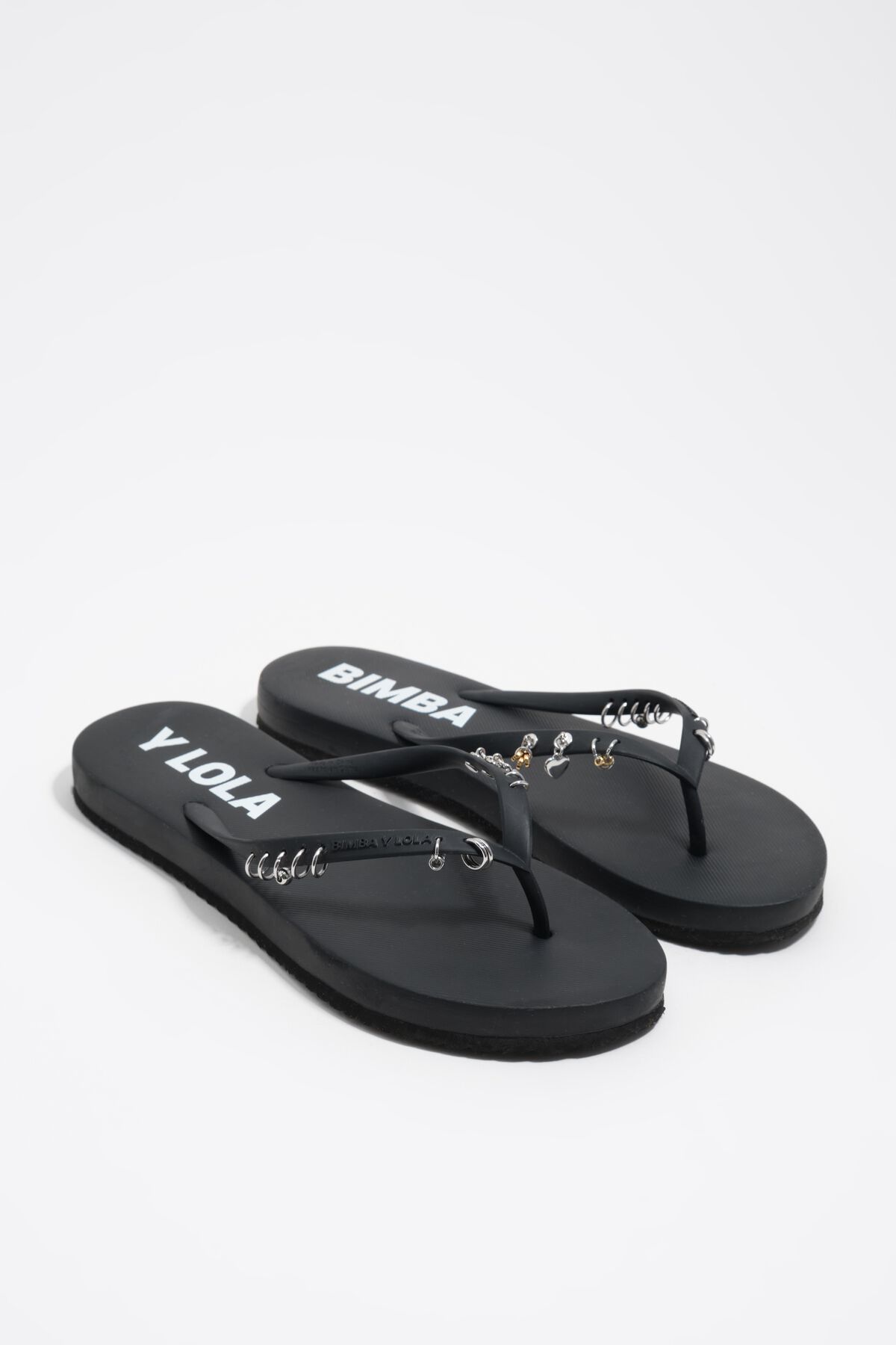 Black flip-flop with piercings