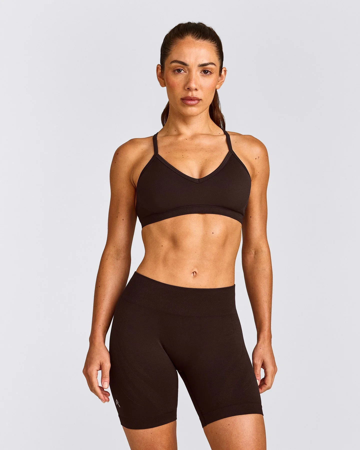 EnhanceLift™ Seamless Strappy Sports Bra with Grey Logo | 70% Cocoa