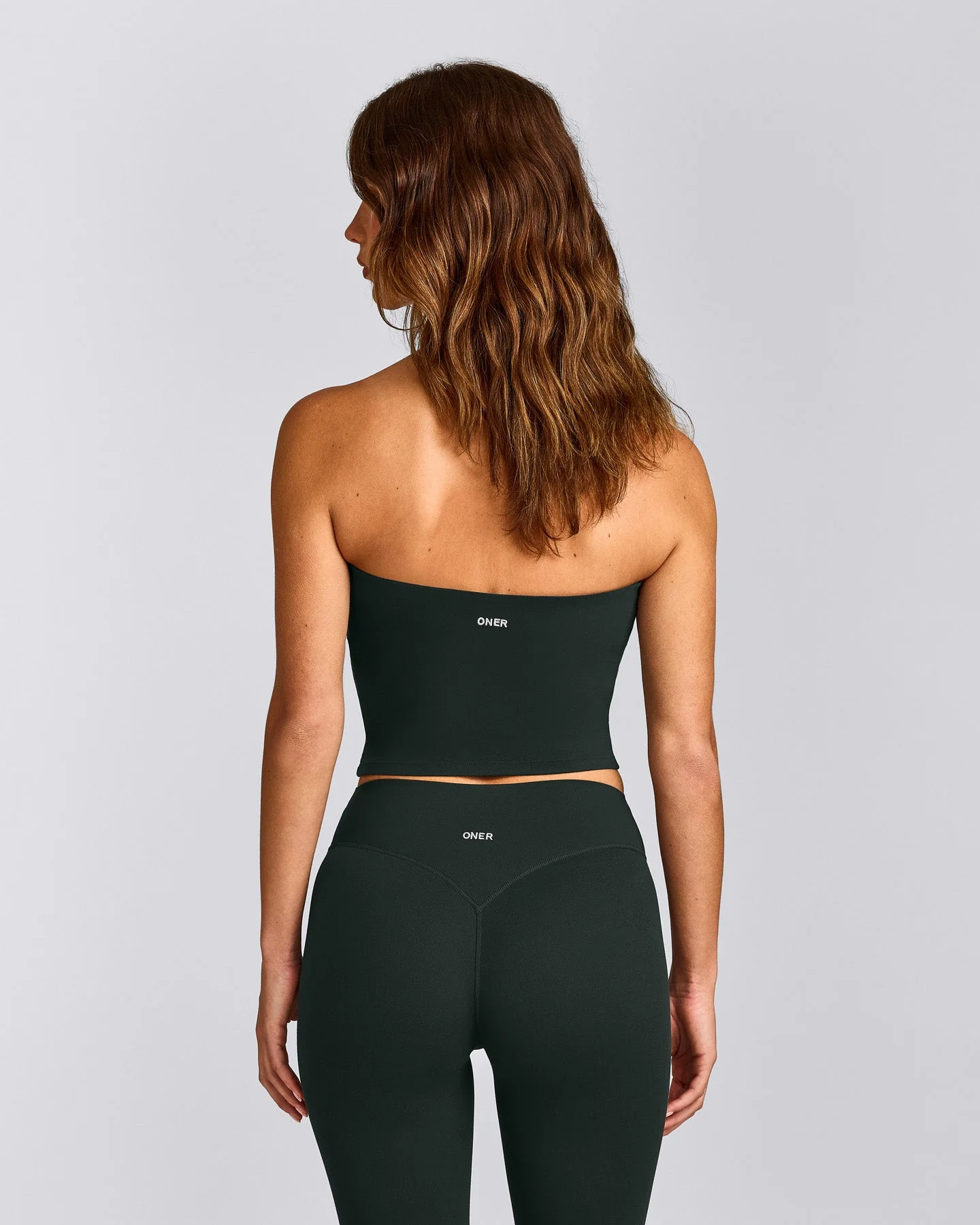 SoftMotion™ Bandeau Mid Vest with Built in Bra Shelf with Grey Logo | Emerald Noir