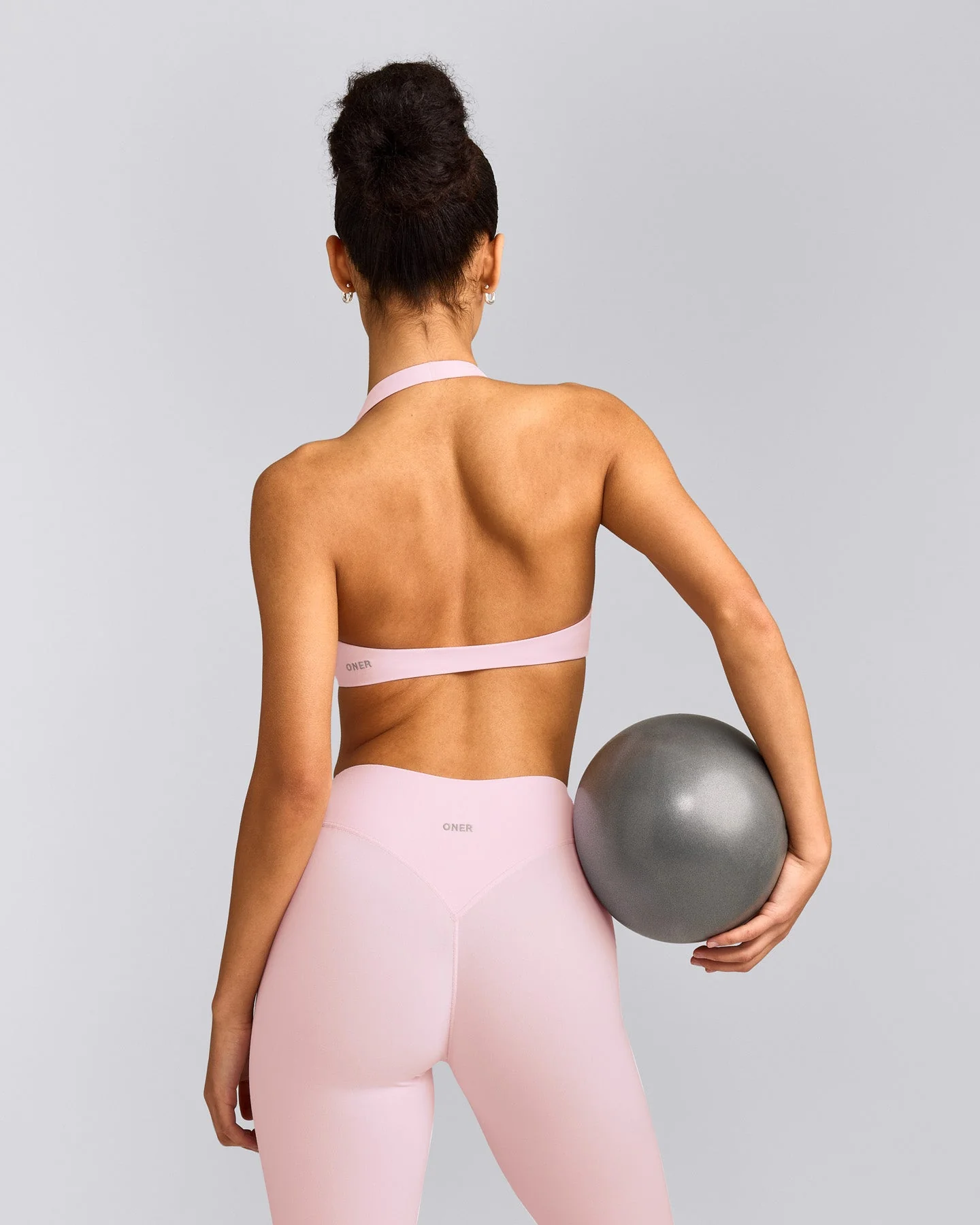 SoftMotion™ Minimal Halter Neck Bralette with Grey Logo | Soft Girl Pink