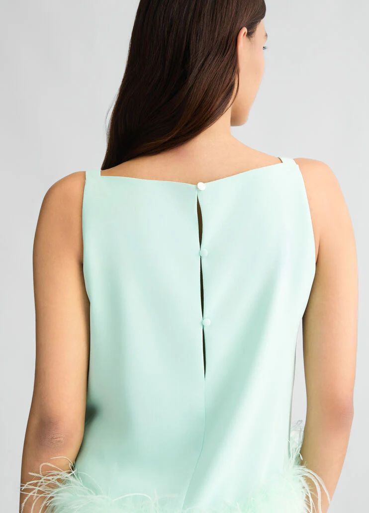 Aqua green top with feathers