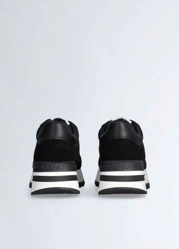 Black sneakers with rhinestone-detailed logo