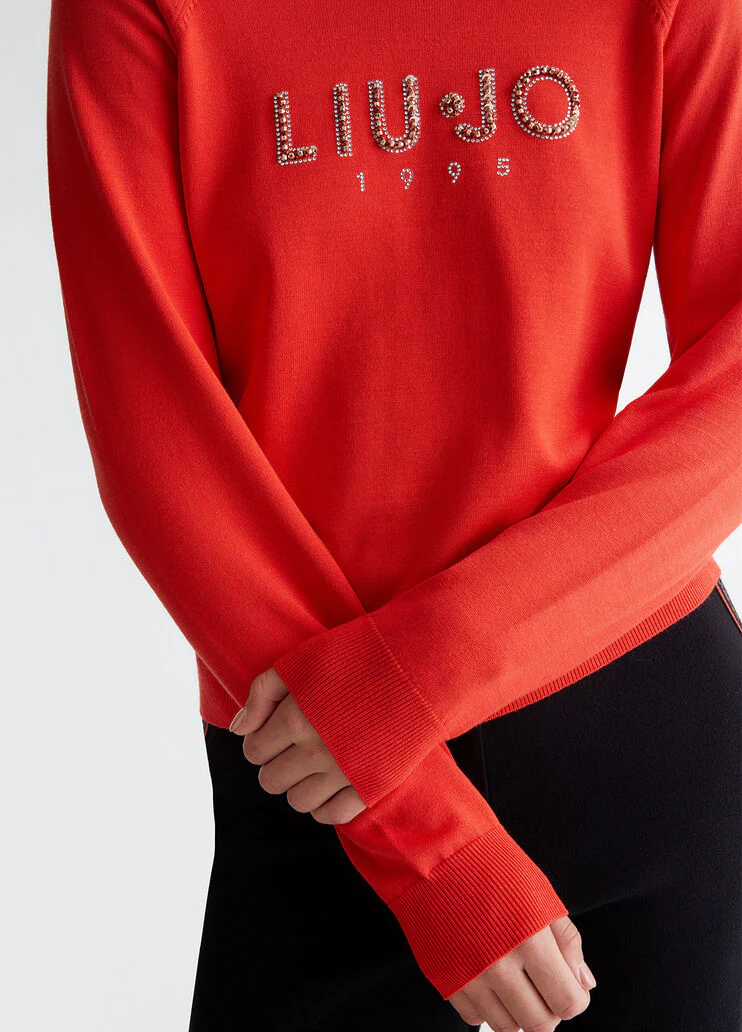 Top with logo and gemstones