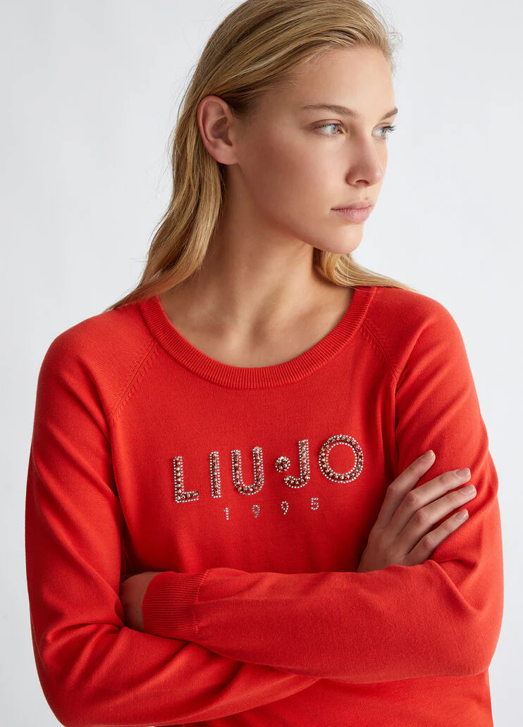 Top with logo and gemstones