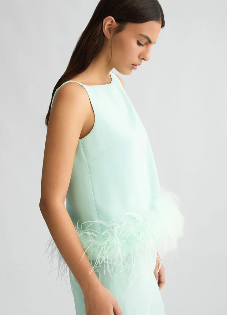Aqua green top with feathers