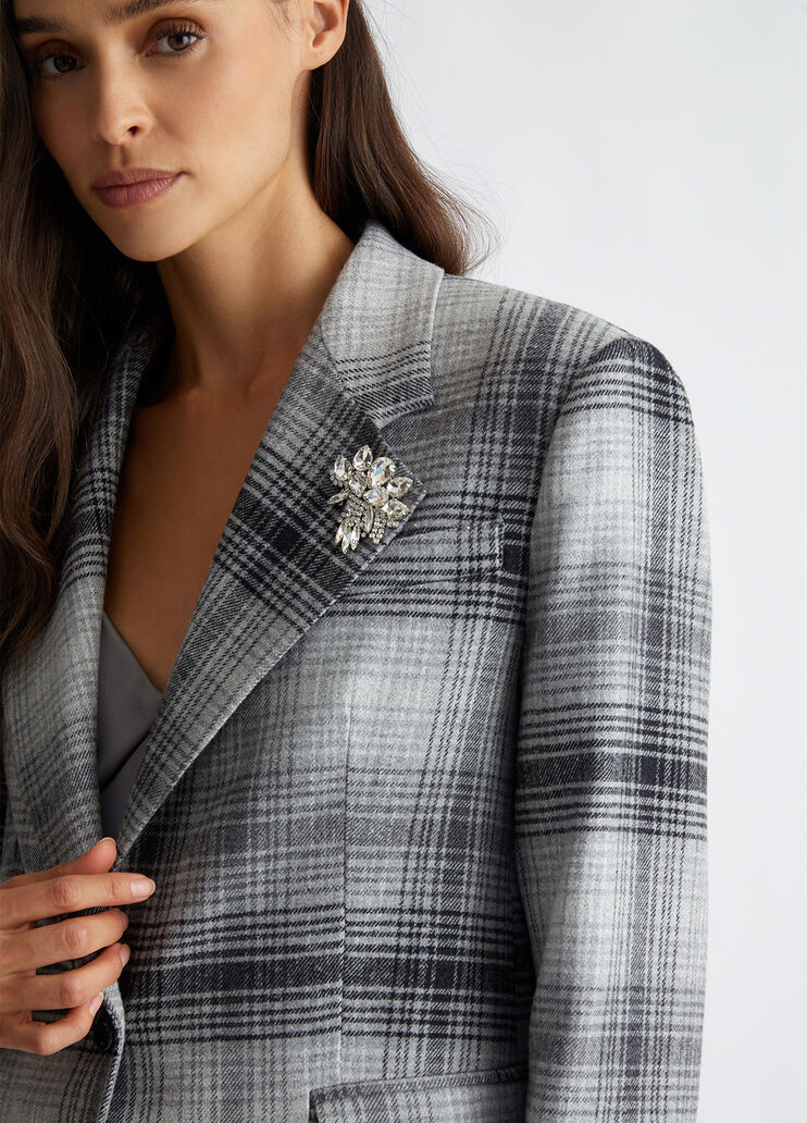 Suit blazer with brooch