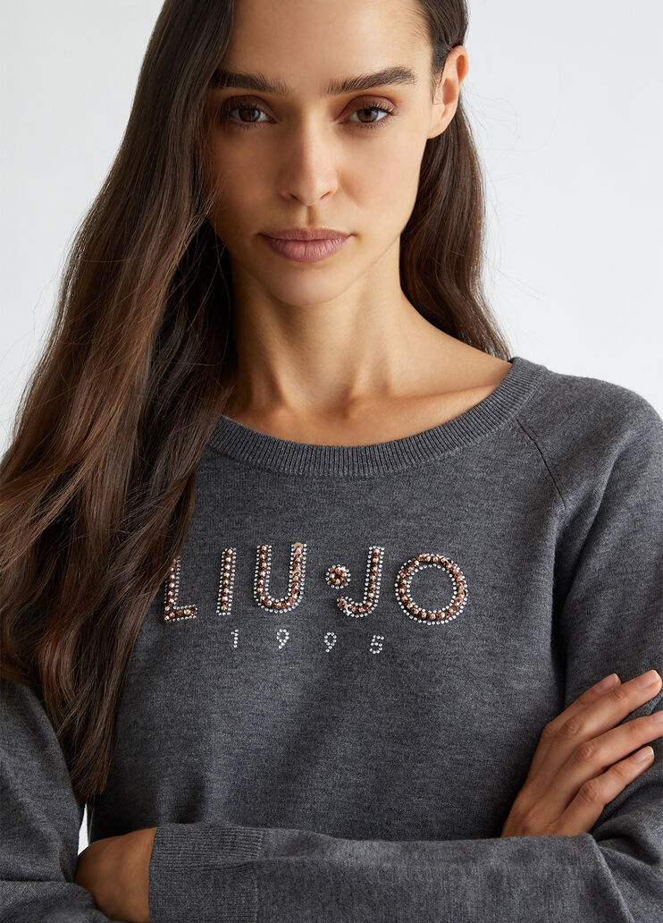Top with logo and gemstones