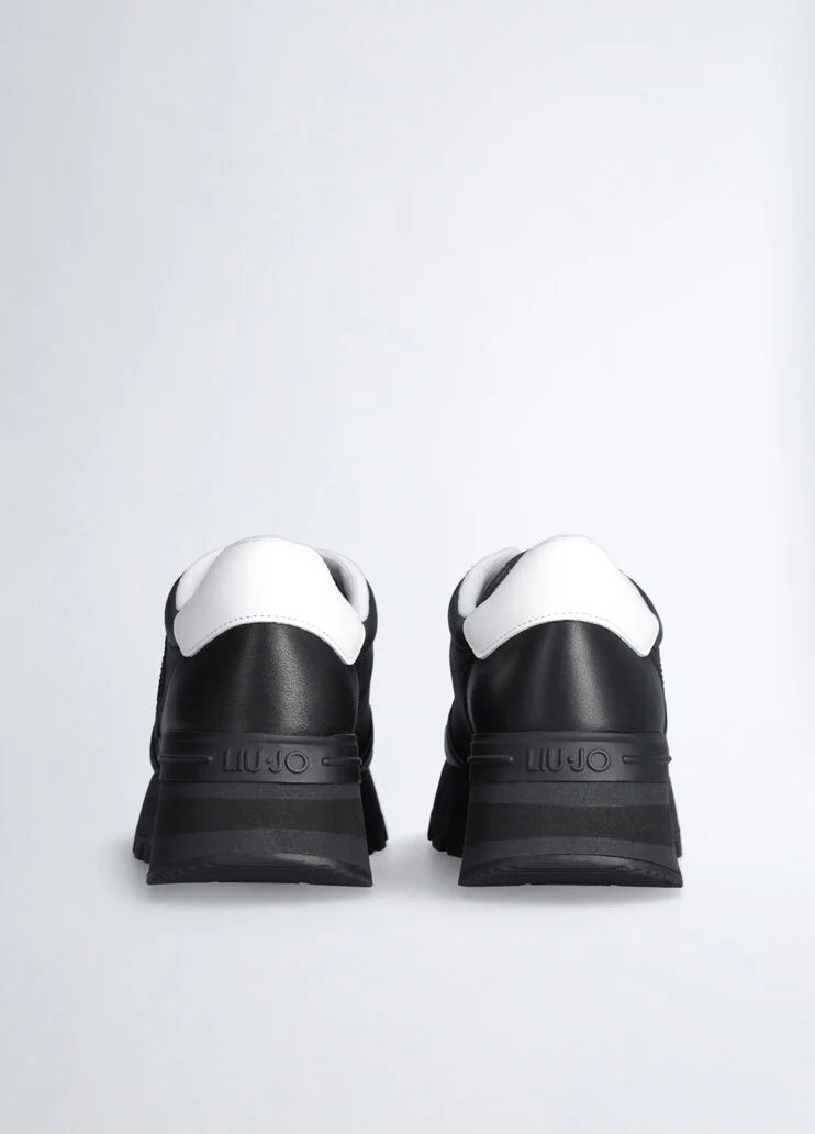 Black leather sneakers with bejewelled logo