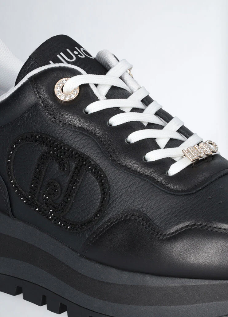 Black leather sneakers with bejewelled logo