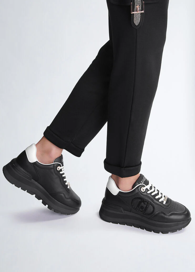 Black leather sneakers with bejewelled logo