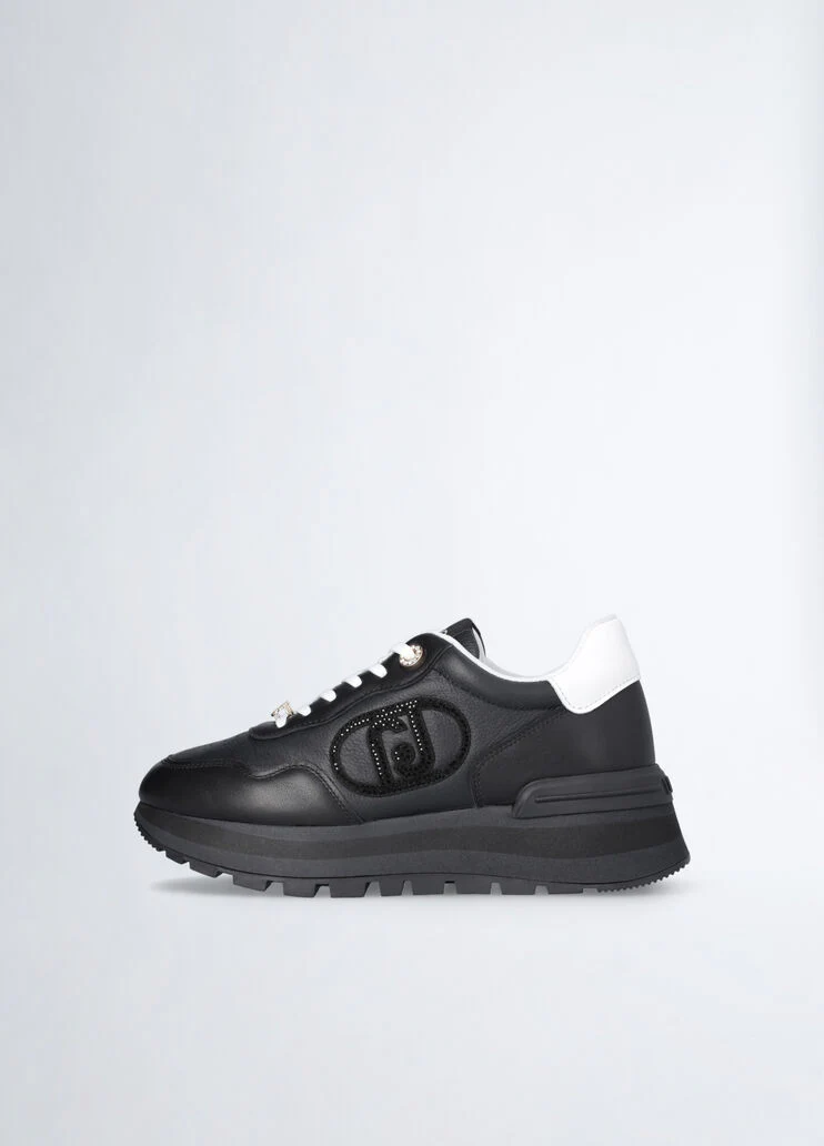 Black leather sneakers with bejewelled logo