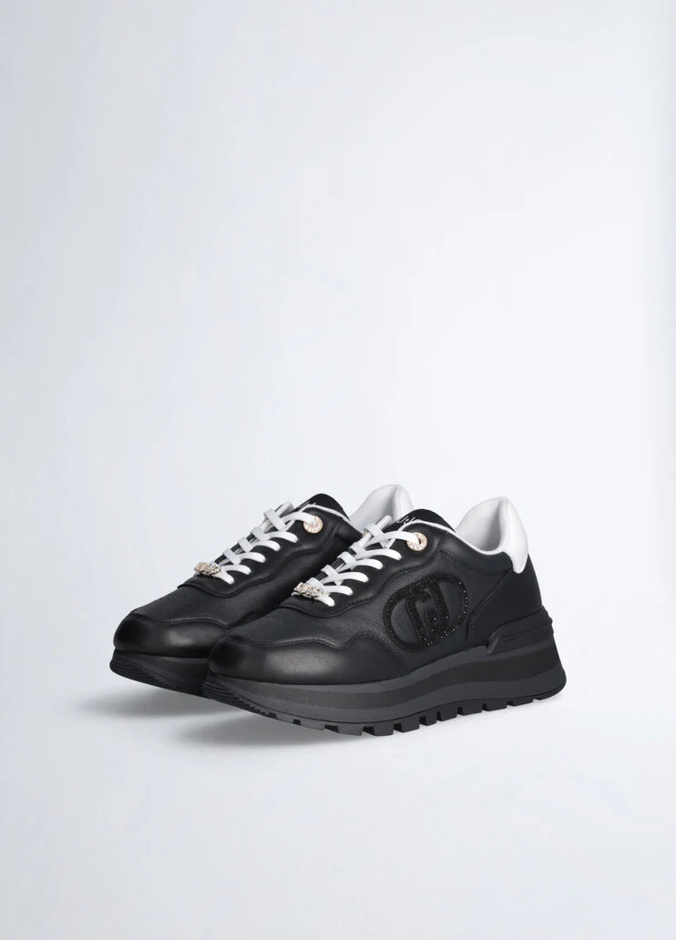 Black leather sneakers with bejewelled logo