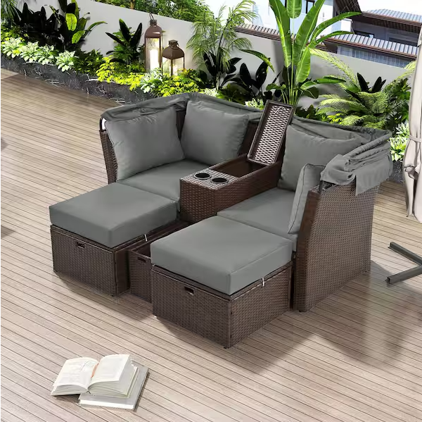 Rattan outdoor patio sofa bed with cushions, folding awning, cup holder and storage box