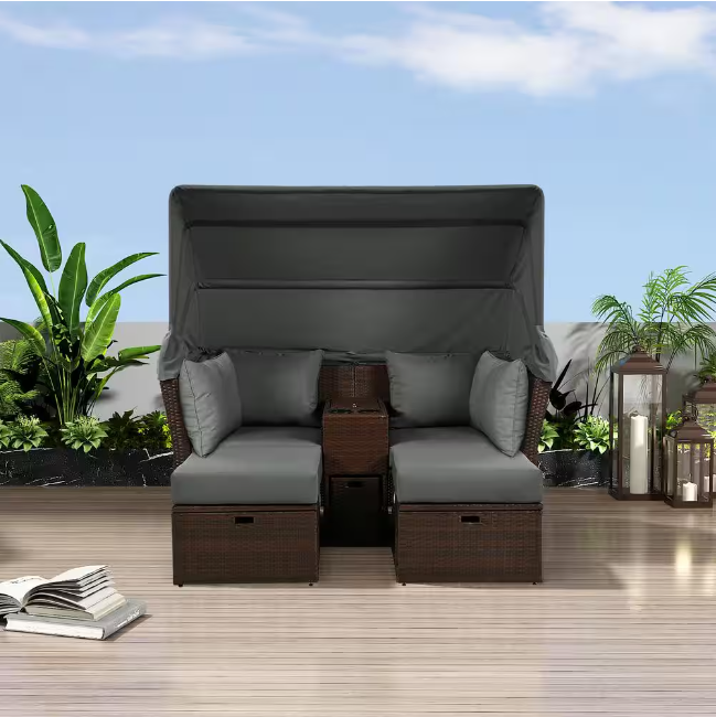 Rattan outdoor patio sofa bed with cushions, folding awning, cup holder and storage box