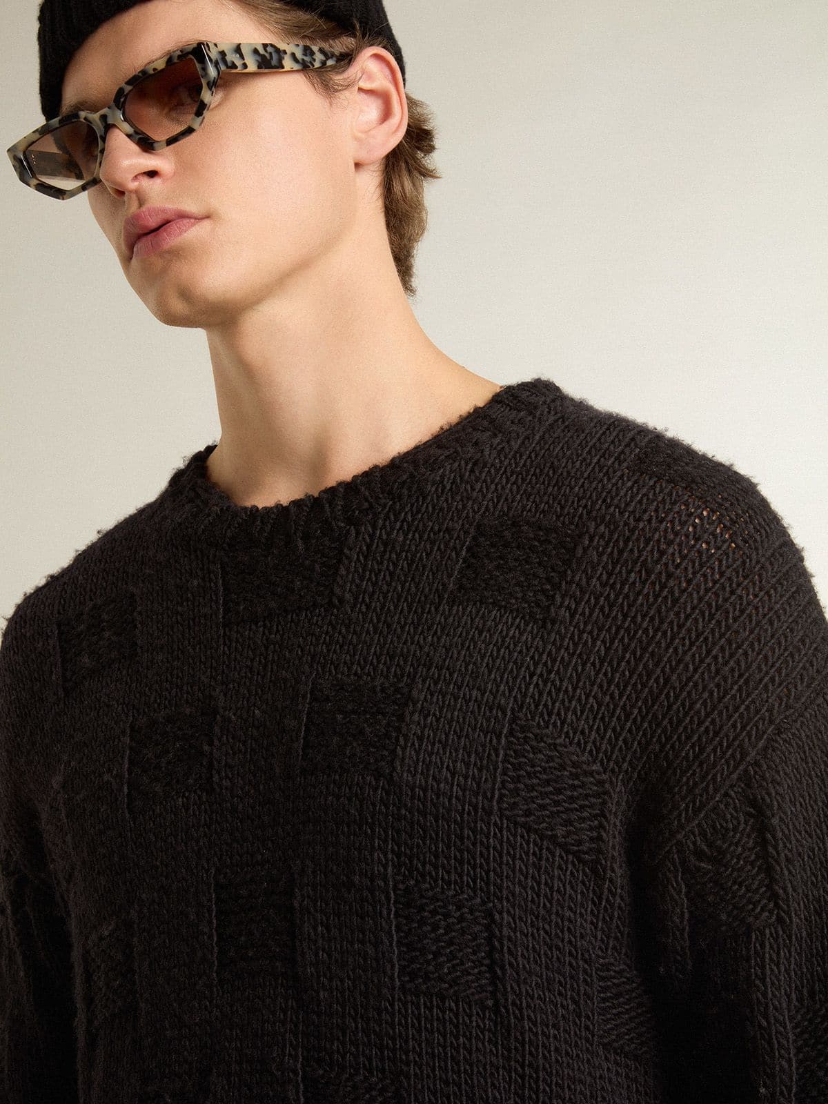 Men's black wool sweater with a distressed effect