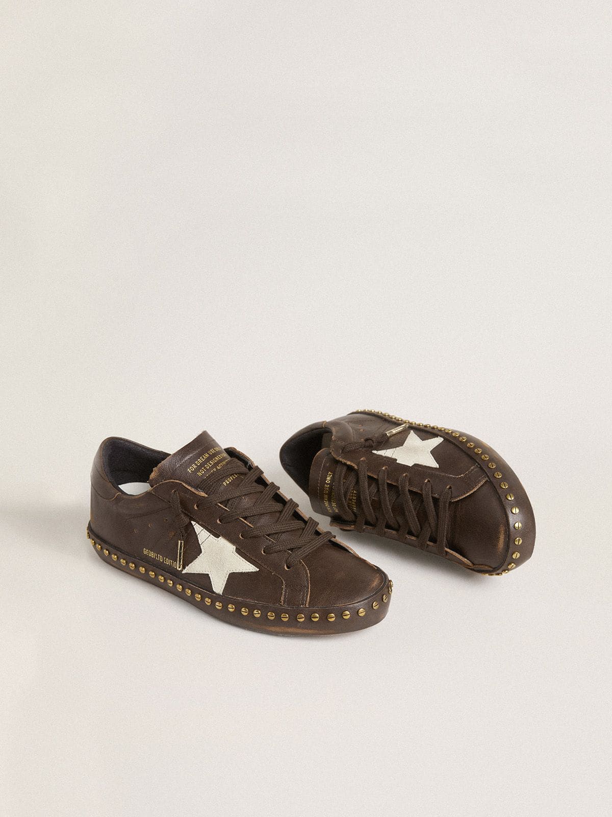 Women’s Super-Star in dark brown leather with cream suede star and studs