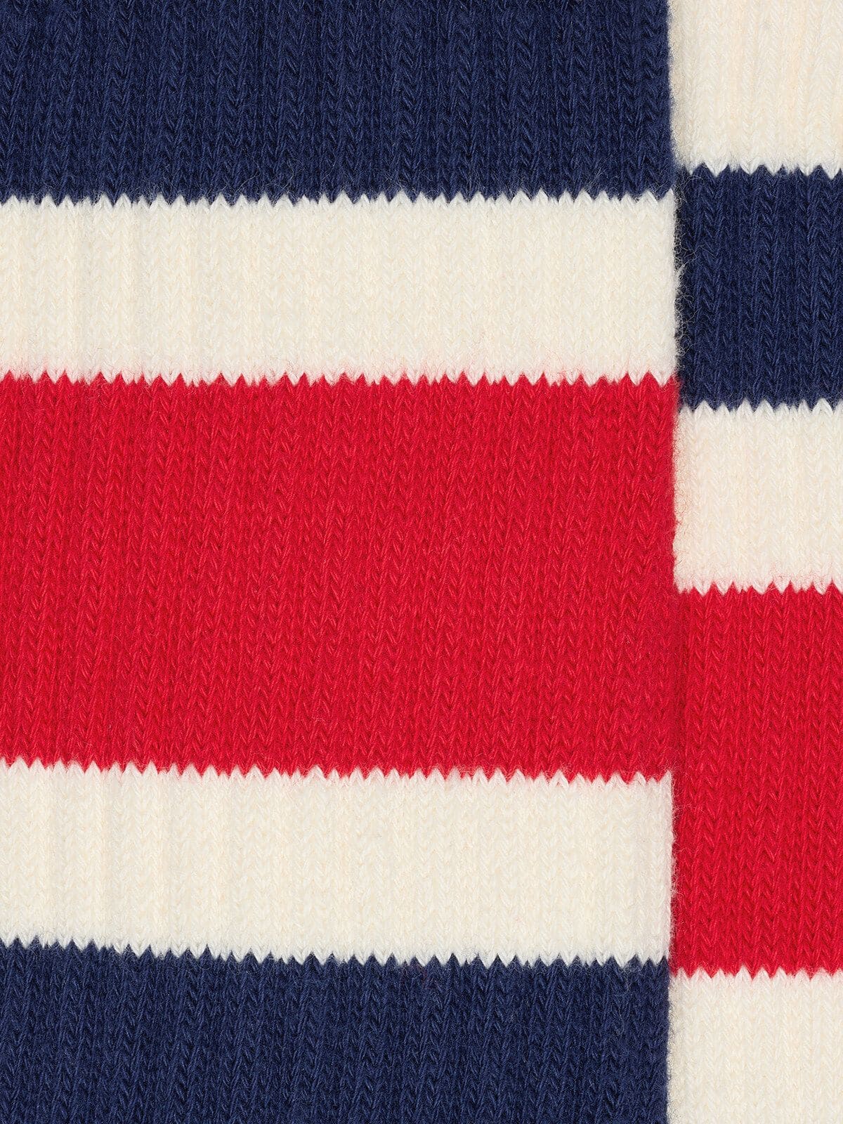 Worn-white socks with blue and red stripes