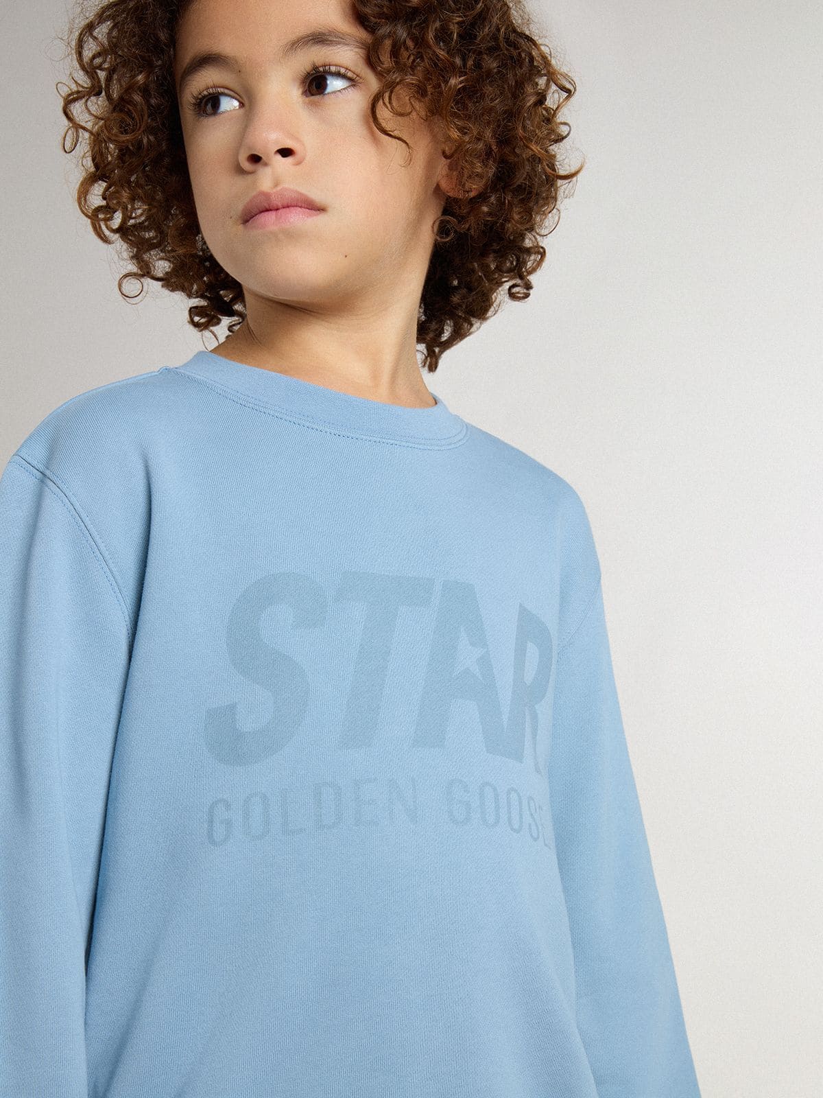 Boys' light blue sweatshirt with lettering on the front