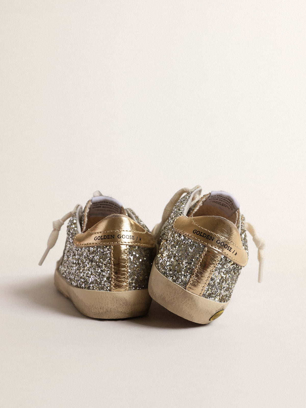 Super-Star Young in glitter with a suede star and gold heel tab