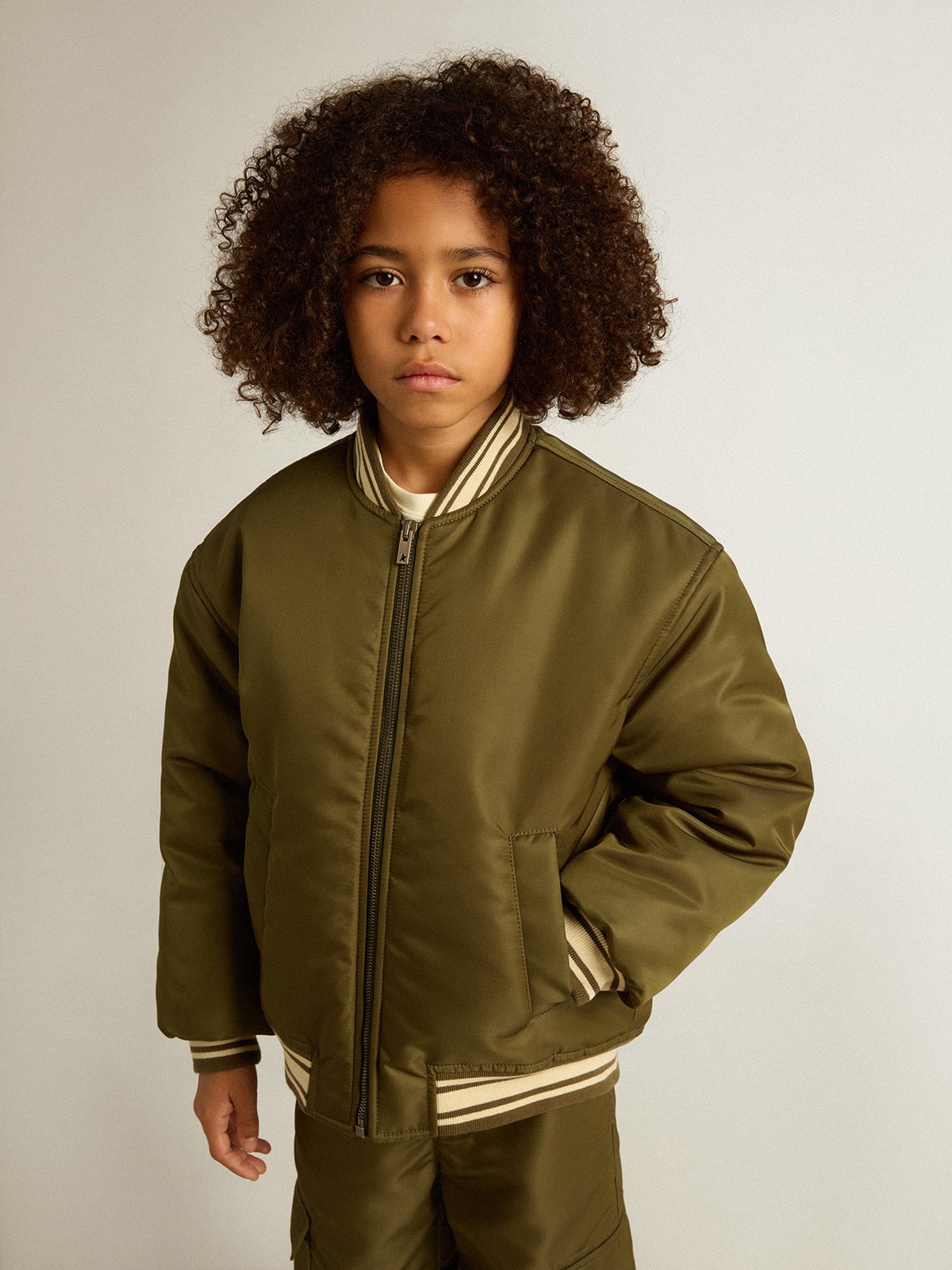 Kids military-green nylon bomber jacket with lettering on the back