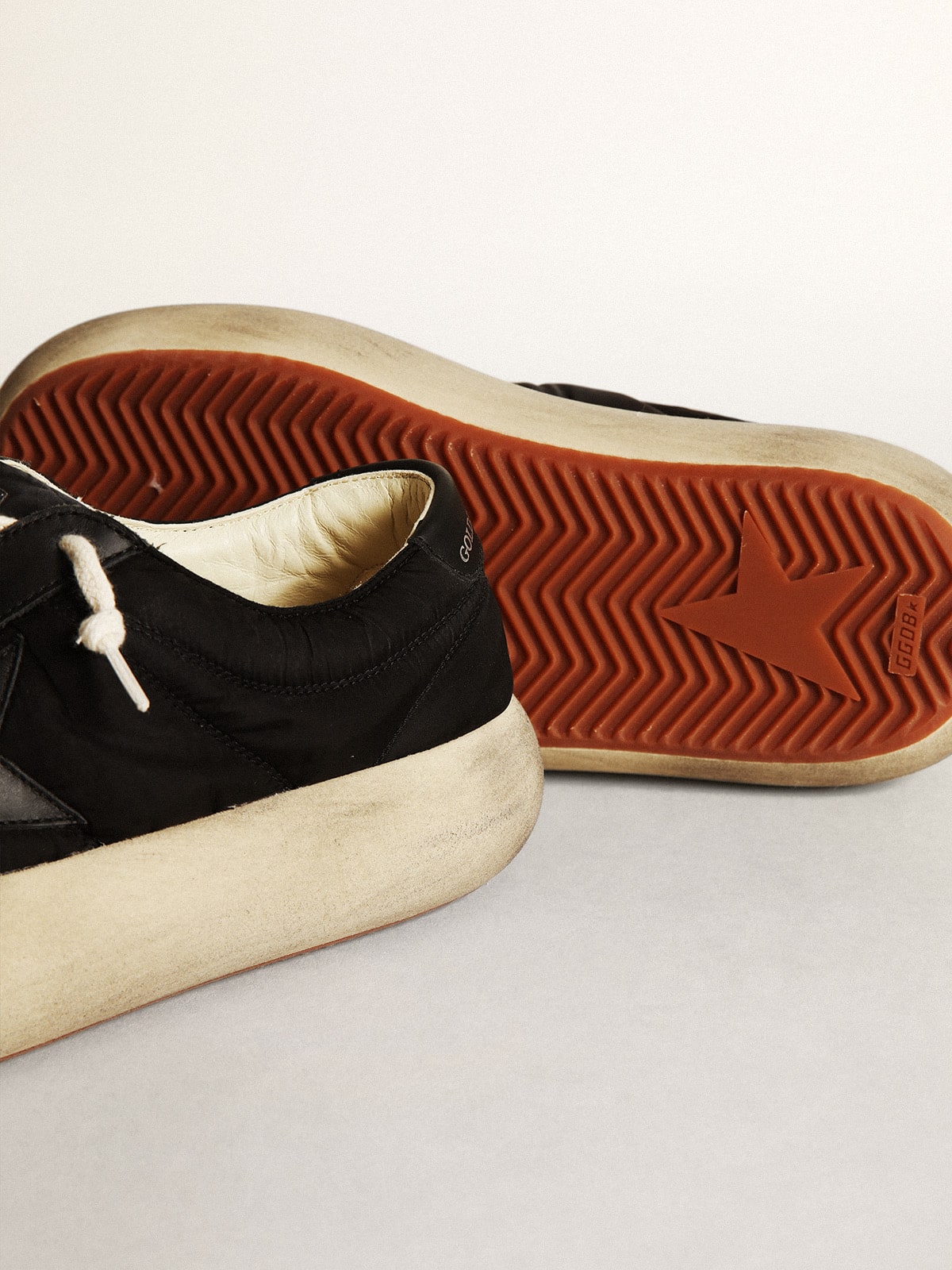 Space-Star shoes in black nylon with black leather star and heel tab