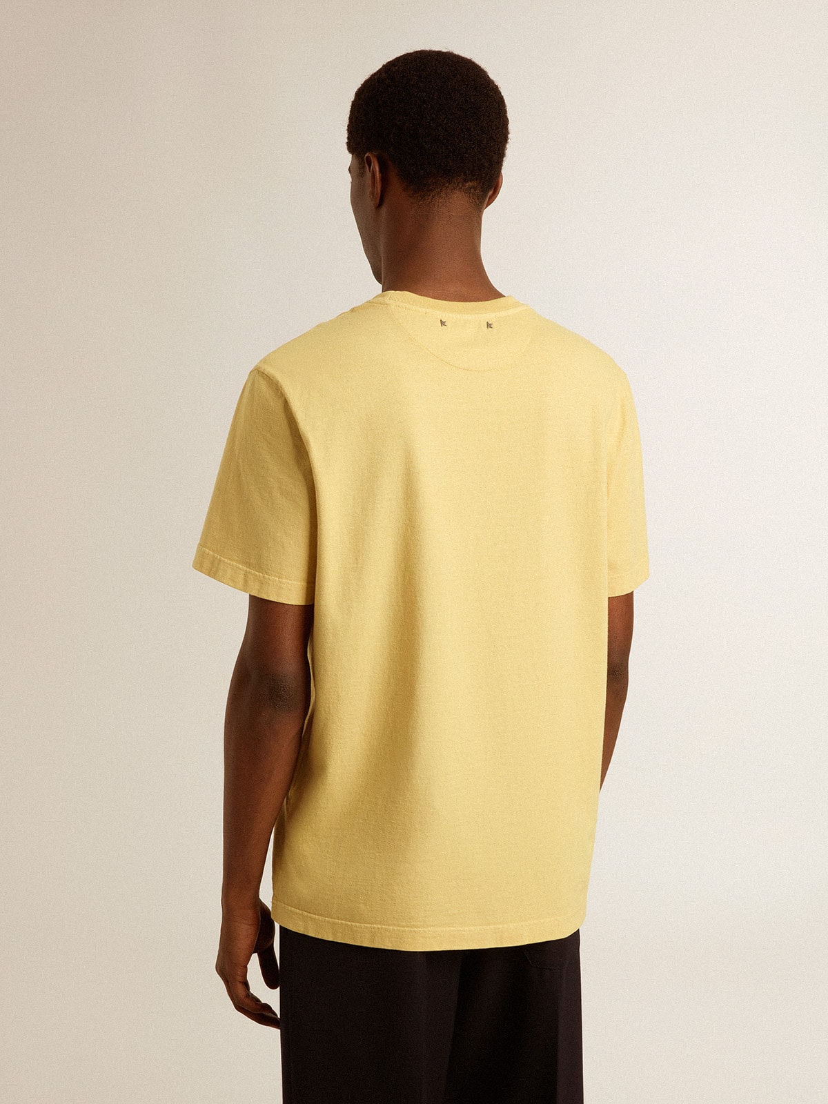 Men's cotton T-shirt in pale yellow with faded lettering
