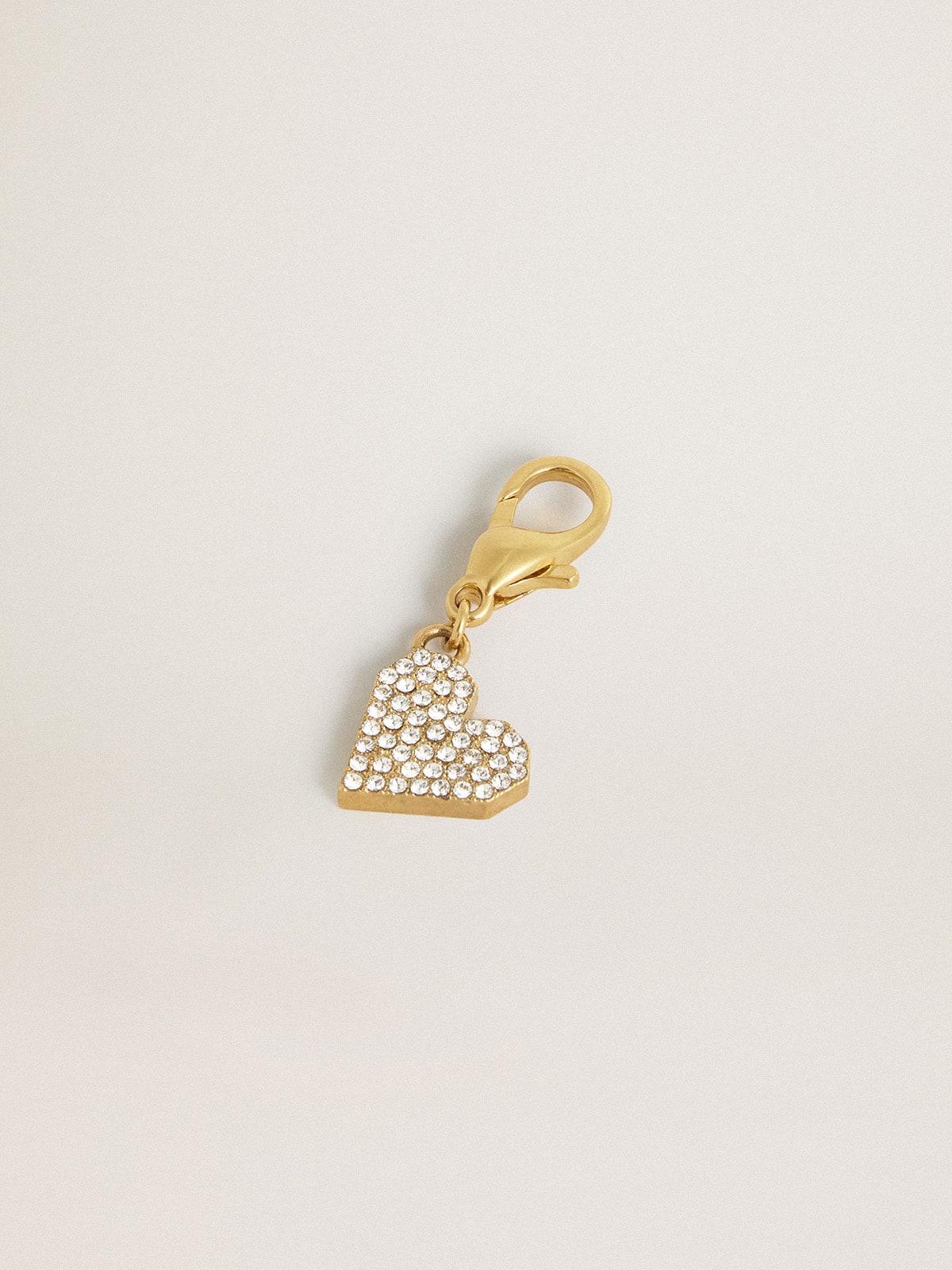 Heart-shaped charm in gold-colored brass with crystals