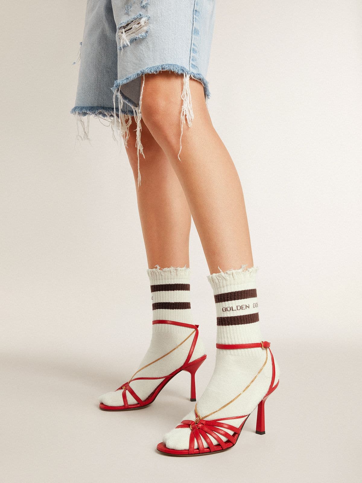 Worn-white socks with distressed details and brown stripes