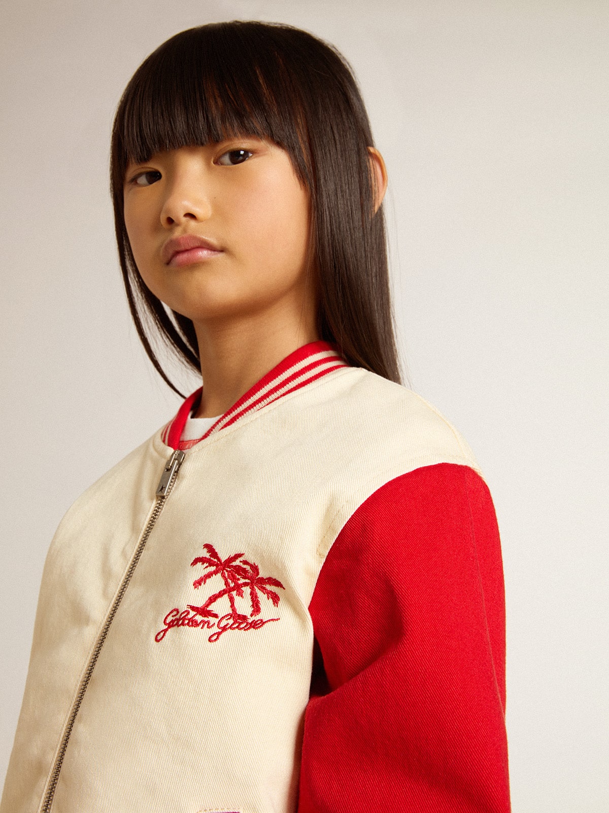 Kids' bomber jacket in beige and red cotton with embroidery on the chest