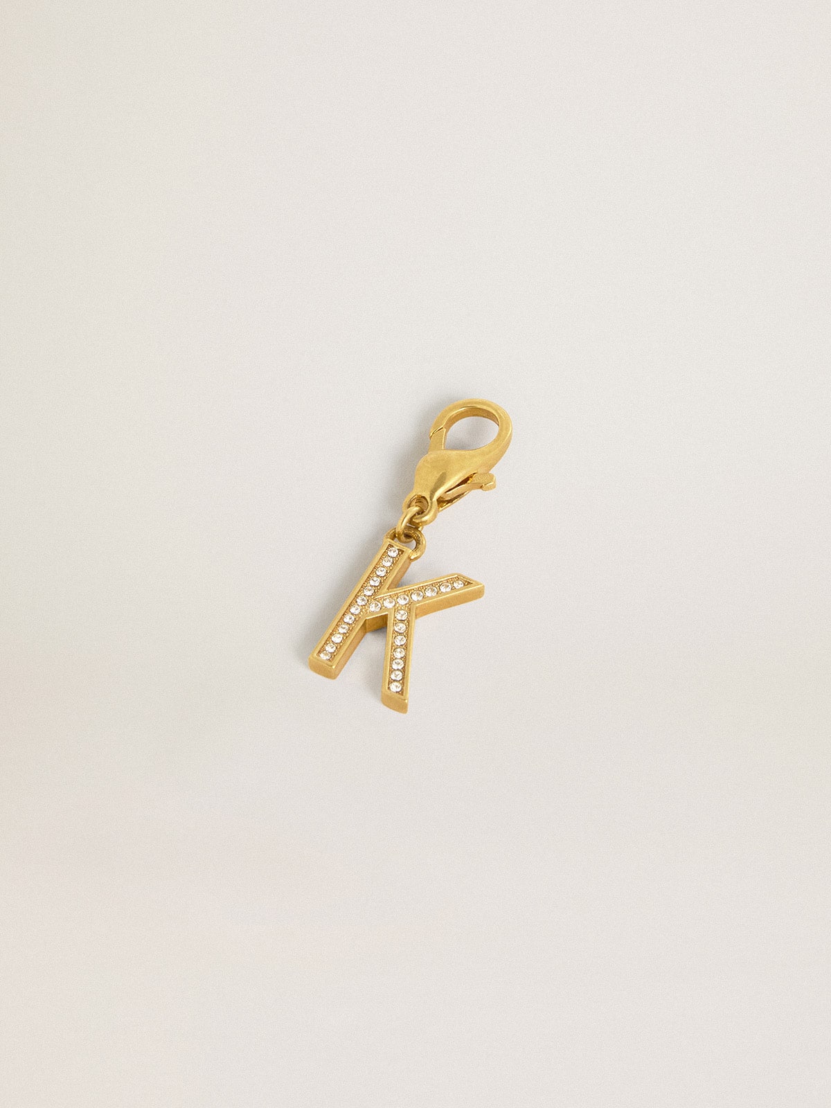 Letter K charm in gold-colored brass with crystals