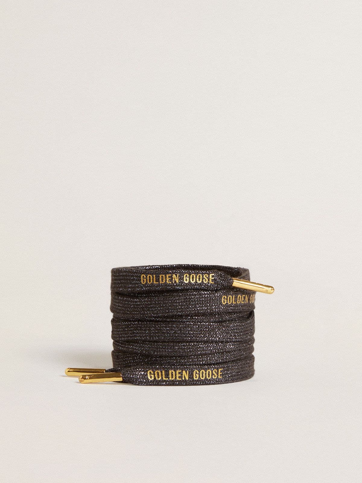 Dark gray lurex laces with contrasting gold logo