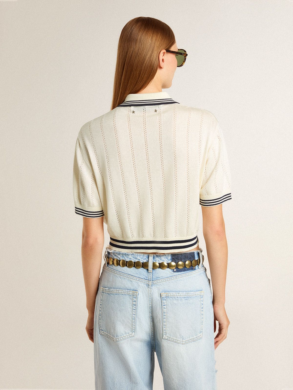 Women's cropped worn-white cotton polo shirt with blue ribbing