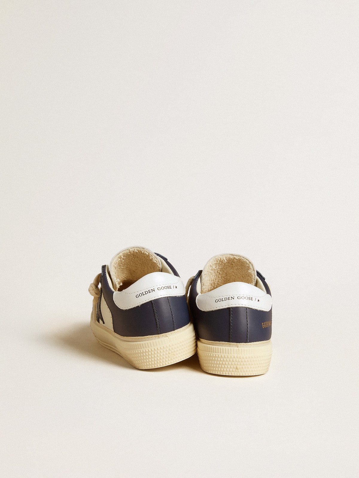 Young May in white and blue leather with leather star and heel tab
