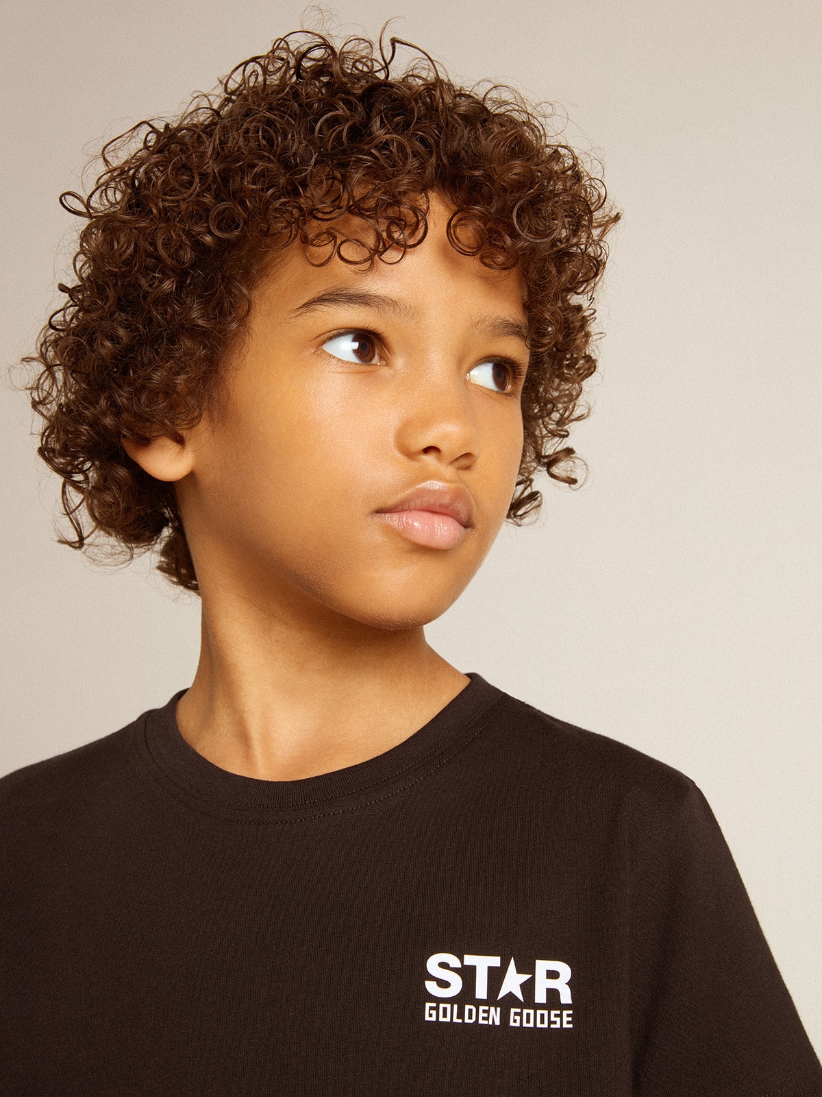 Black T-shirt with contrasting white logo on the front and maxi star on the back