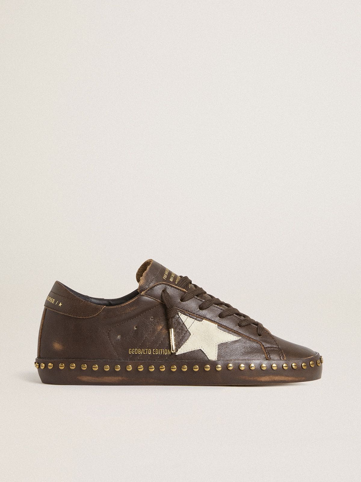 Women’s Super-Star in dark brown leather with cream suede star and studs