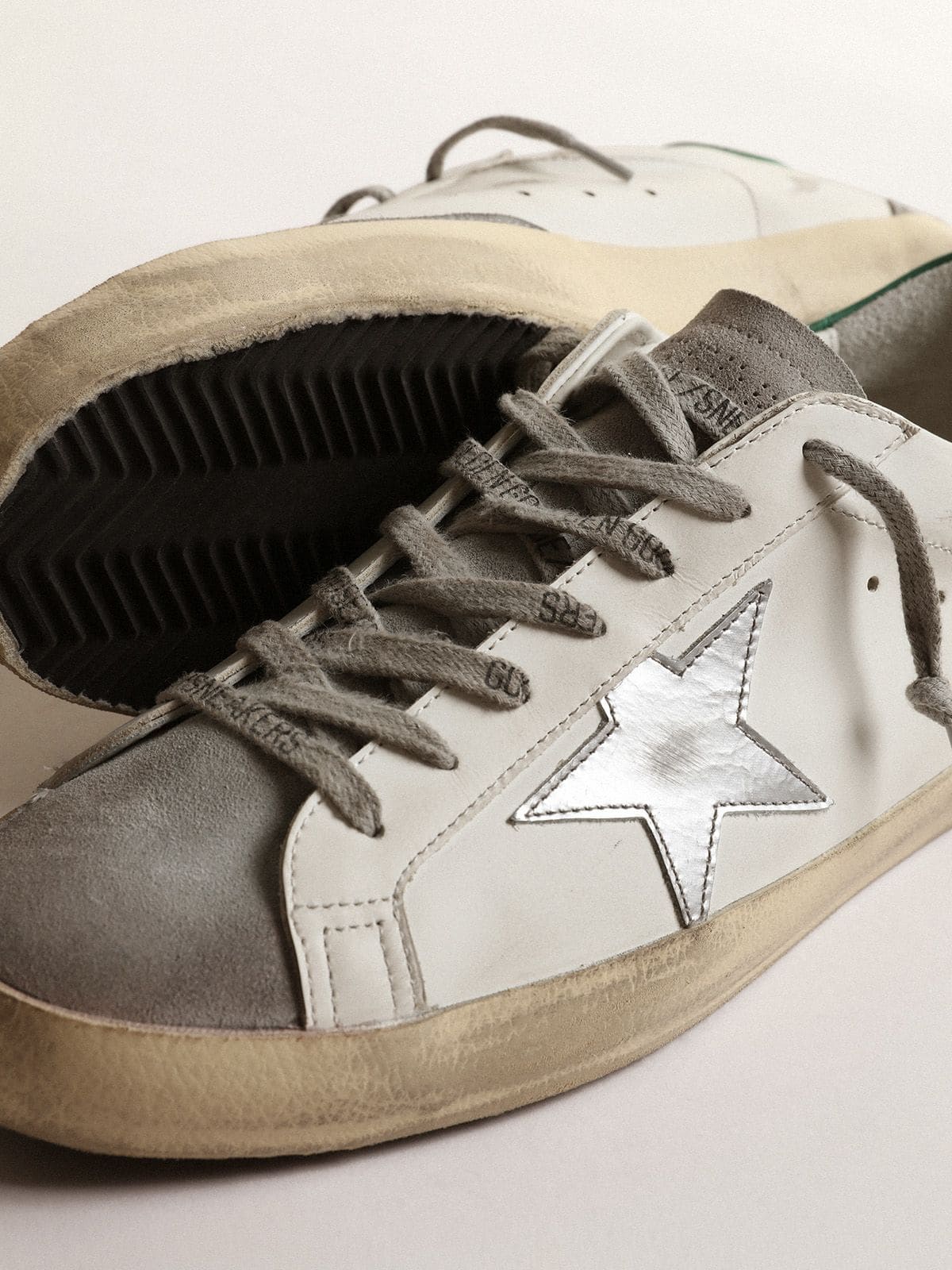 Men’s Super-Star in white leather with silver star and green heel tab