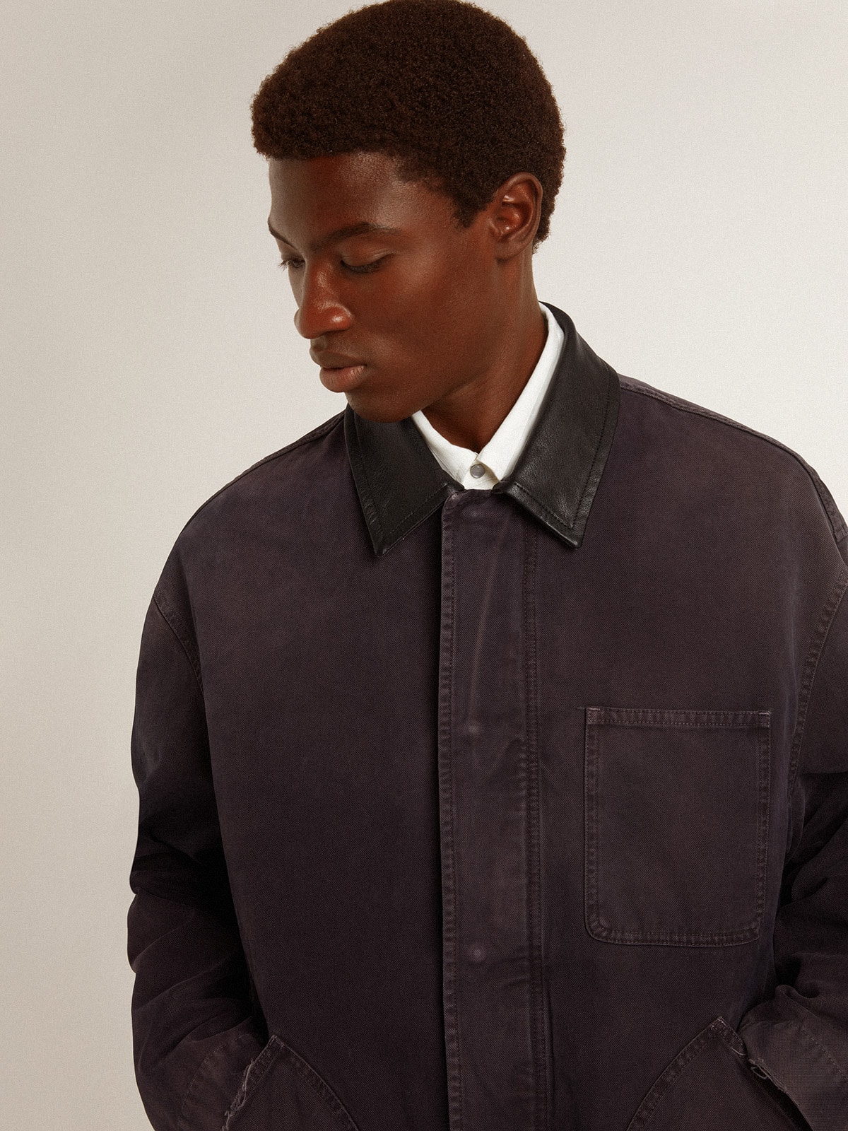 Men's denim jacket with distressed details and leather collar