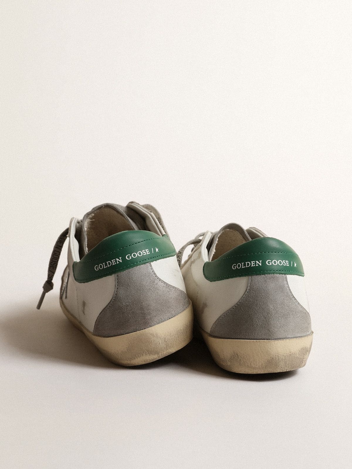 Men’s Super-Star in white leather with silver star and green heel tab