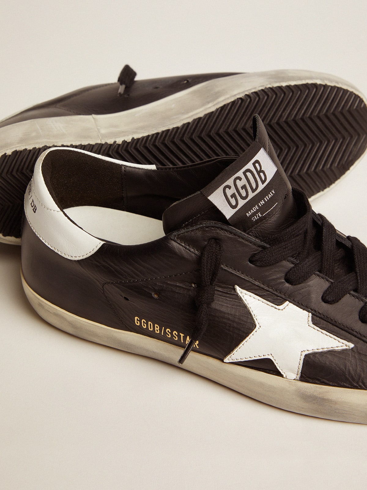 Women’s Super-Star in black leather with white leather star and heel tab