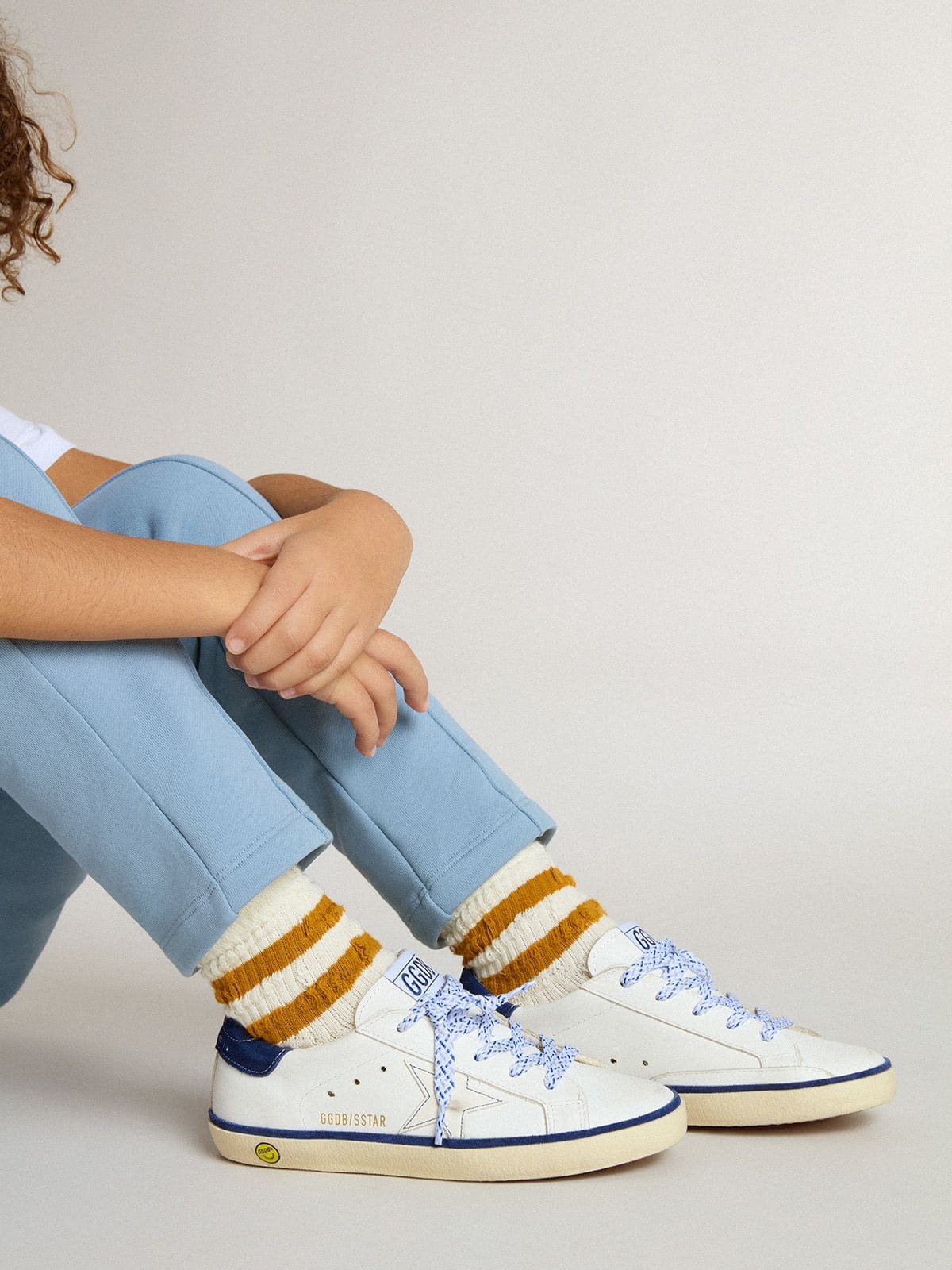 Junior Super-Star in white leather with blue suede heel tab