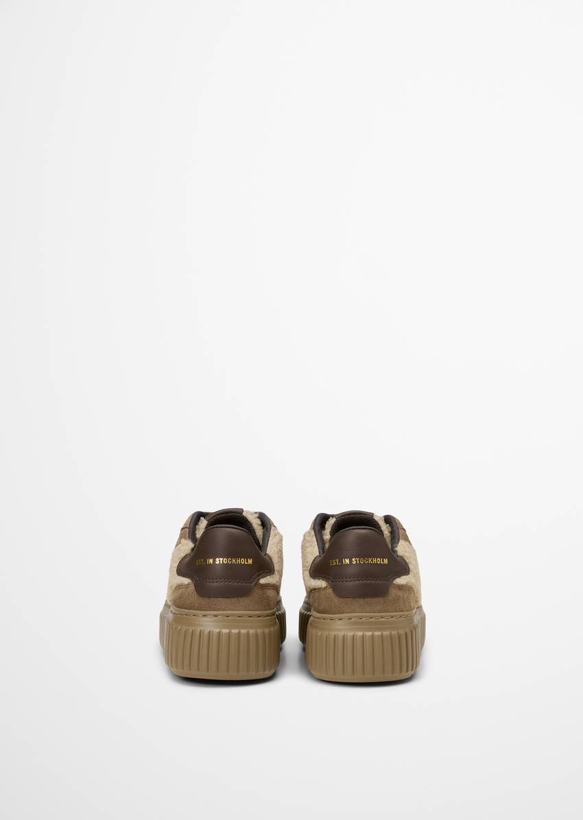 Platform sneaker made from suede and teddy fur