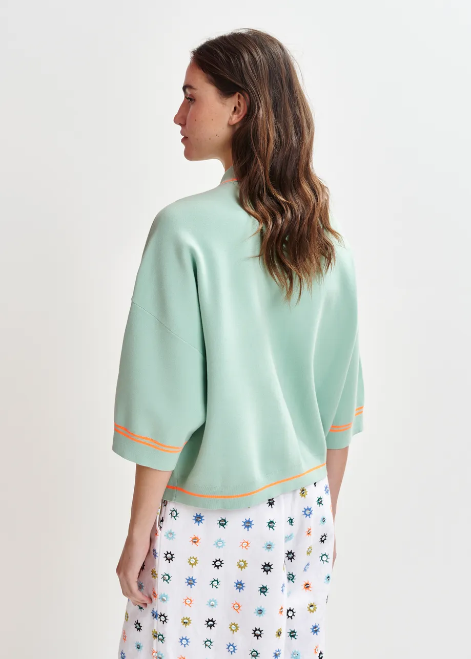 Zwart-witte cardigan met bloemetjesknopen en contrastboord